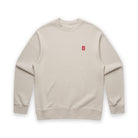 Beige sweatshirt with a small red logo on a white background